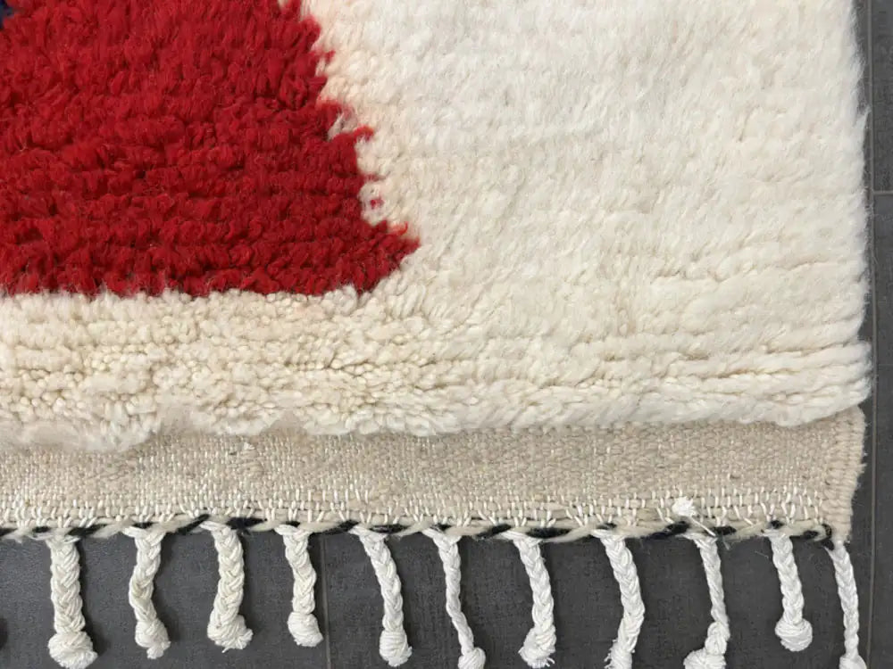Franges torsadées blanches d’un tapis azilal en laine naturelle