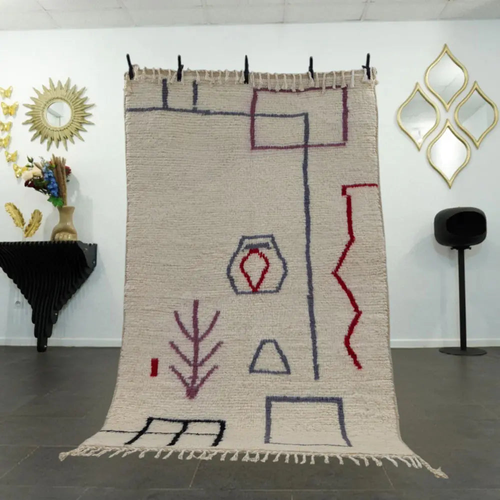Tapis Beni Ouarain en laine naturelle avec motifs graphiques colorés, fait main au Maroc