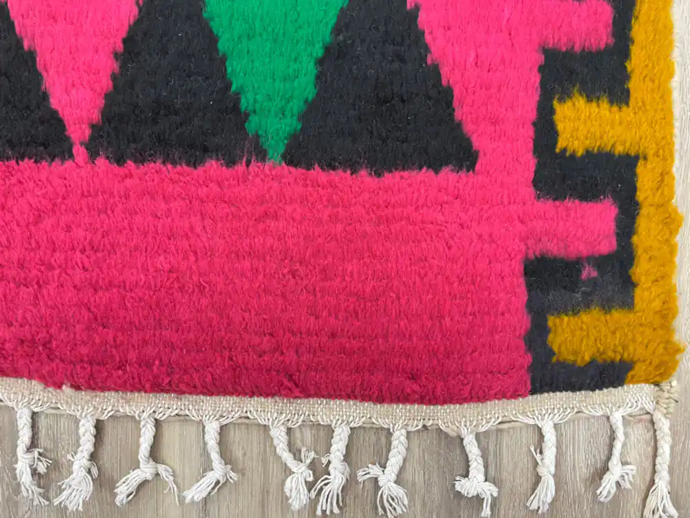 Gros plan sur la laine naturelle épaisse du tapis berbère Azilal