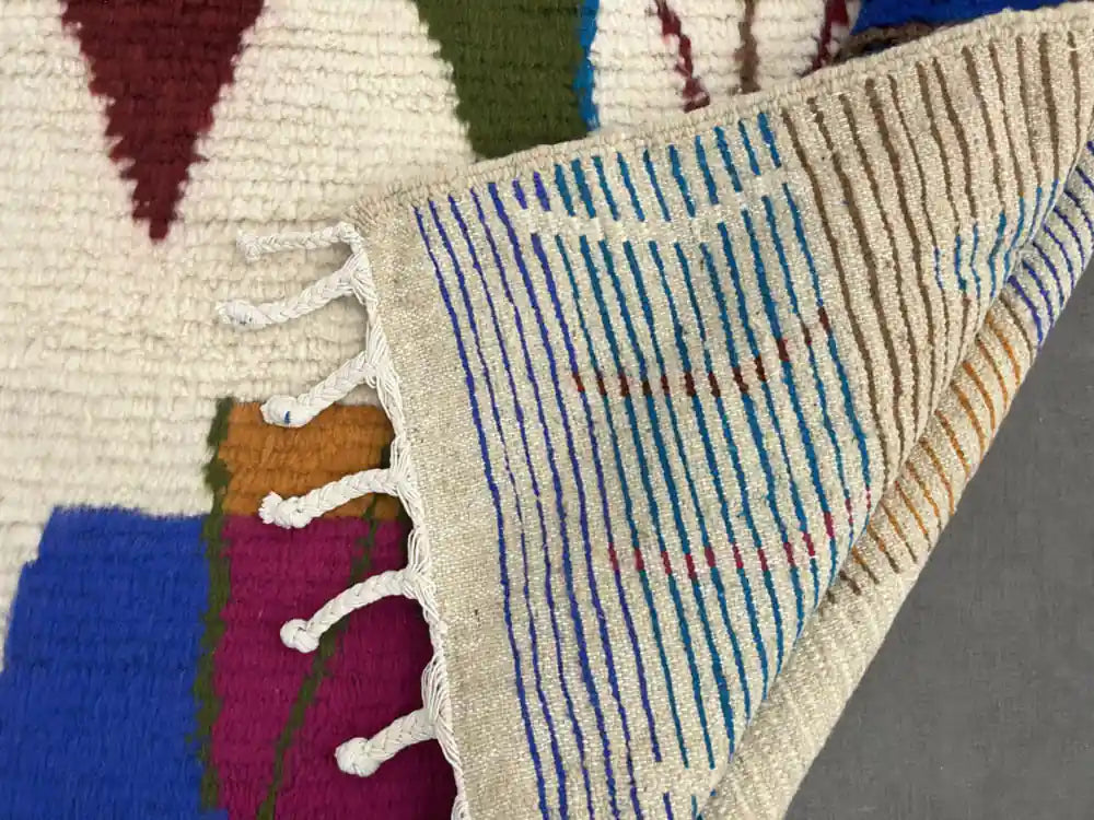 Dos d’un tapis Azilal multicolore avec lignes colorées et nouage fait main