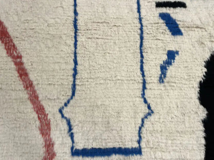 Détail motif bleu rouge noir sur tapis berbère Azilal en laine naturelle, fait main Maroc