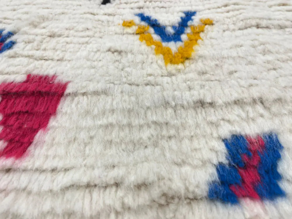 Gros plan sur la texture épaisse de la laine du tapis azilal